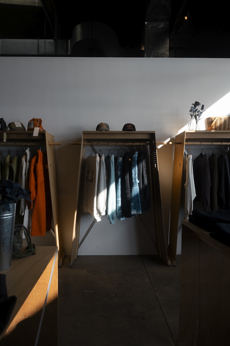 Moody boutique interior with racks of dark garments